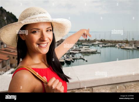 woman walks a city on the beach on hot summer day un beautiful red