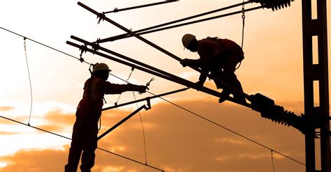 Silhouette Of Two Electricians Working · Free Stock Photo
