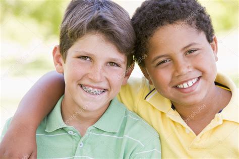 Two Young Male Friends Outdoors Smiling — Stock Photo © Monkeybusiness