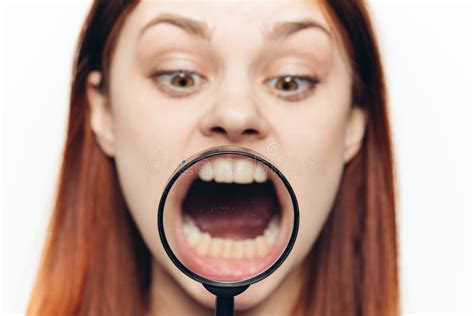 Pretty Woman Grimacing With Magnifying Glass Near Face Close Up Stock