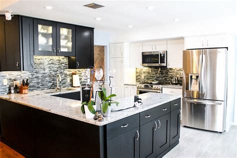 White cabinets with granite countertops. The contrast of the white countertop with the black ...