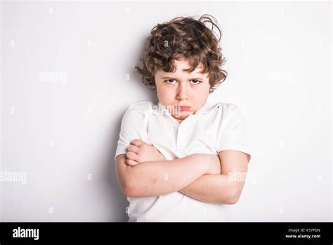 Head And Shoulders Close Up Portrait Of Young Boy With Sulk Attitude