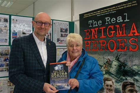 Phil Shanahan Holding His Book The Real Enigma Heroes With Carol
