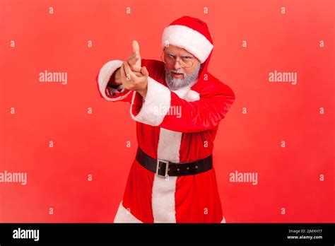 i ll kill you portrait of angry elderly man in santa claus costume pointing finger guns to