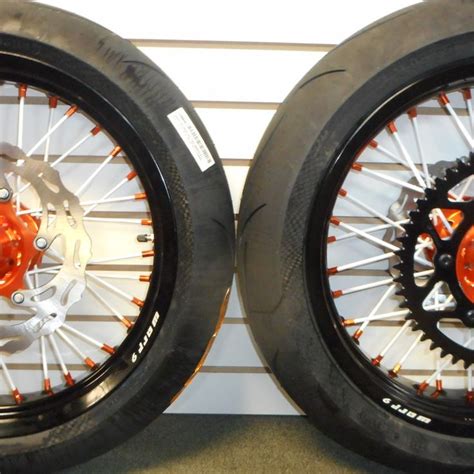 Two Black And Orange Wheels With Spokes On Them