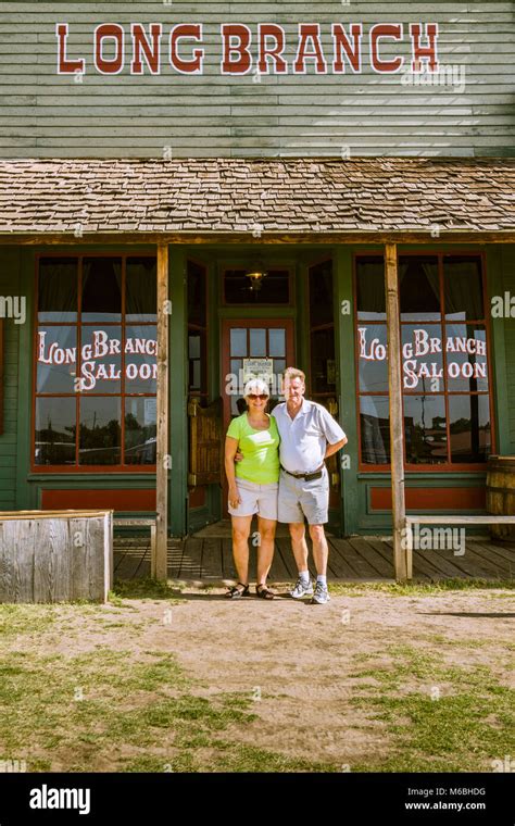 Couple Outside Long Branch Saloon In Dodge City Kansas Building Is
