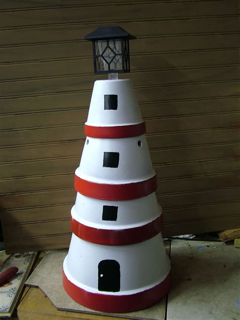 Lighthouse Made Out Of Flower Pots With Solar Light On Top Lighthouse
