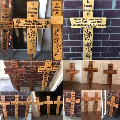 Several Wooden Crosses With Names On Them In Front Of A Brick Wall And