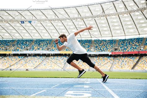 Young Sprinter Running On Athletics Track Sponsored Sponsored