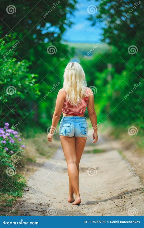 Back View Of Walking Woman Beautiful Blonde Girl In Motion B Royalty Free Stock Image