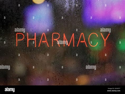 Neon Pharmacy Sign In Wet Window Stock Photo Alamy