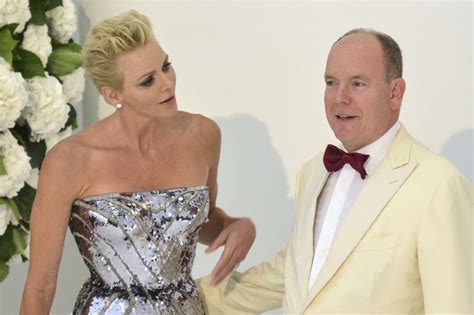 prince albert ii of monaco with his wife princess charlene pose as they arrive at the 69th
