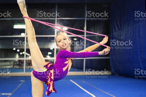Gymnastics is an ideal sport for girls to participate in, as it's a beautiful sport that teaches young children how to balance, jump, and balance on their hands and feet. Girl Is Engaged In Rhythmic Gymnastics Stock Photo ...