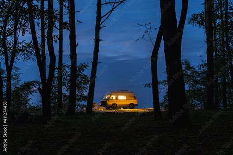 Yellow Vintage Camper Van Parked In The Forest At Night Camping In The