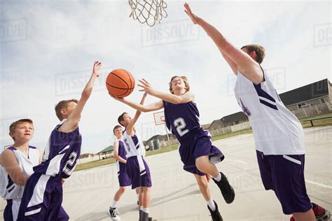 Caucasian boys playing basketball on court - Stock Photo ...
