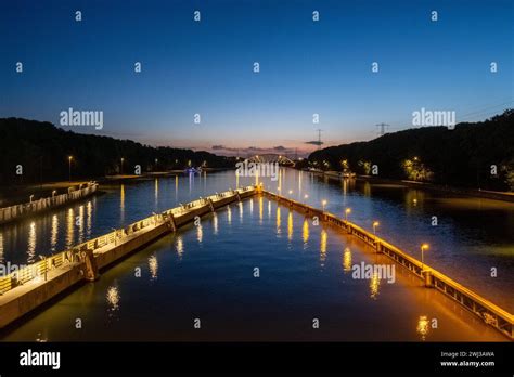 As twilight descends, this image showcases a river walkway illuminated