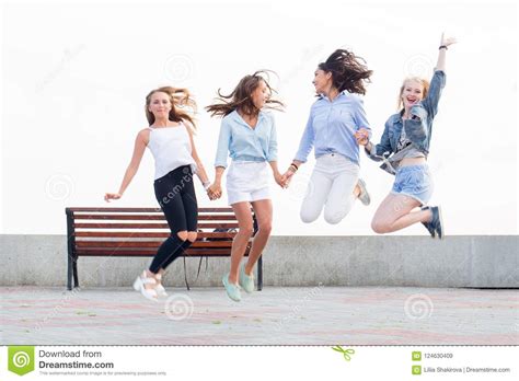 Four Beautiful Crazy Joyful Girlfriends Jumping And Having Fun In Park Stock Image Image Of