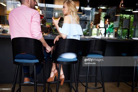 Rear View Of Man Touching Angry Young Womans Knee At Bar Photo Getty