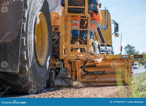 Road Construction Workers Repairing Highway Road On Sunny Summer Day