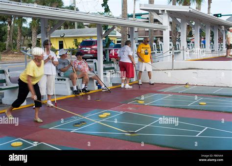 New Smyrna Beach Florida Senior Retired Couples Playing Shuffleboard In