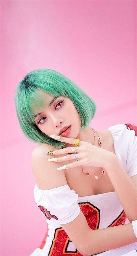 A Woman With Green Hair And Piercings Posing For A Photo In Front Of A