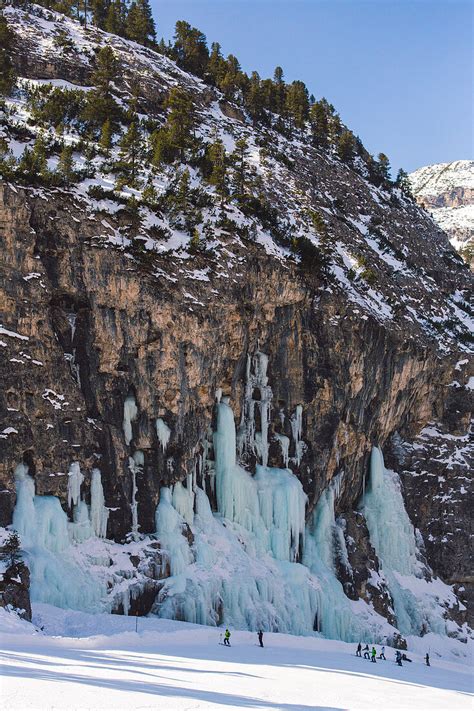 Skiers Underneath The Frozen Waterfall License Image 71078765