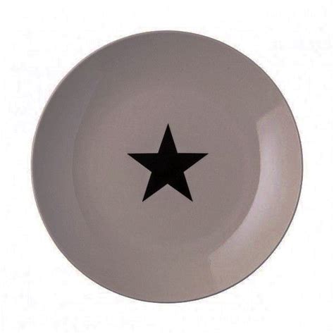 A White Plate With A Black Star On The Front And Bottom Against A