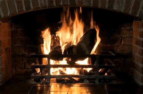 A Fire Burning In A Fireplace With Lots Of Flames