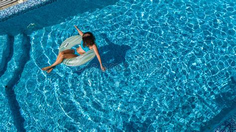 Aerial View Of Beautiful Girl In Swimming Pool From Above Swim On