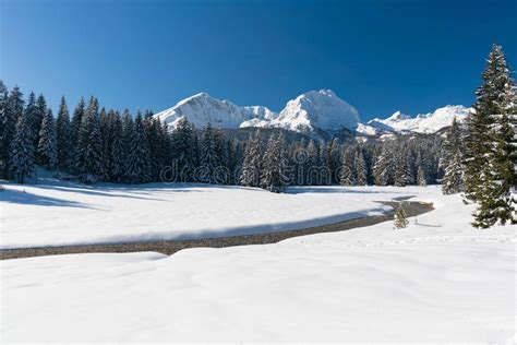Idyllic Winter Wonderland With Mountain Lake And Snow