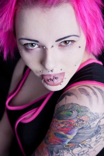 Young Woman With Tattoos Peircings And Pink Hair Stock Photo Download