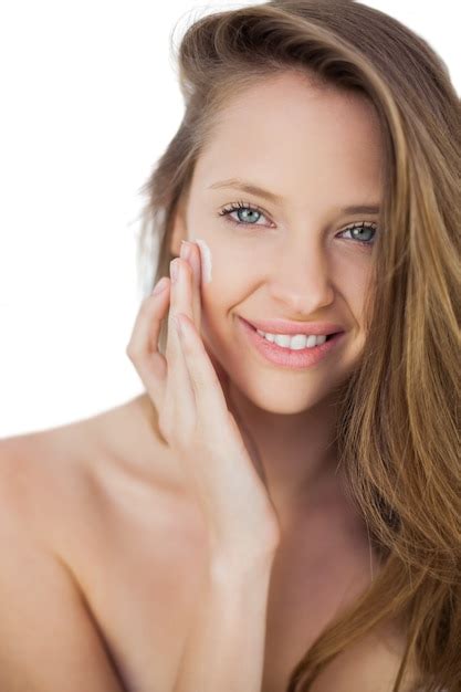 Premium Photo Smiling Brunette Model Rubbing Her Cheek With Cream