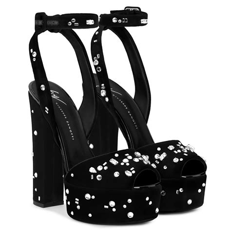 a pair of black high heeled shoes with white polka dots on the heels and platform
