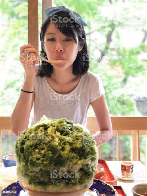 Beautiful Asian Woman Enjoying Her Big Kakogori Shaved Ice Dessert Mixed With Green Tea Syrup