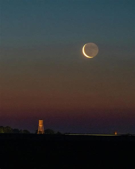 Crescent Moon Rising Over The Water Tower Photograph By Christopher V