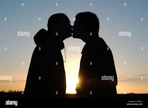 Silhouette Of Two Men Kissing At Sunset Stock Photo Alamy