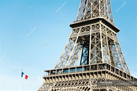 Paris France Eiffel Tower And French Flag In A Sunny Day