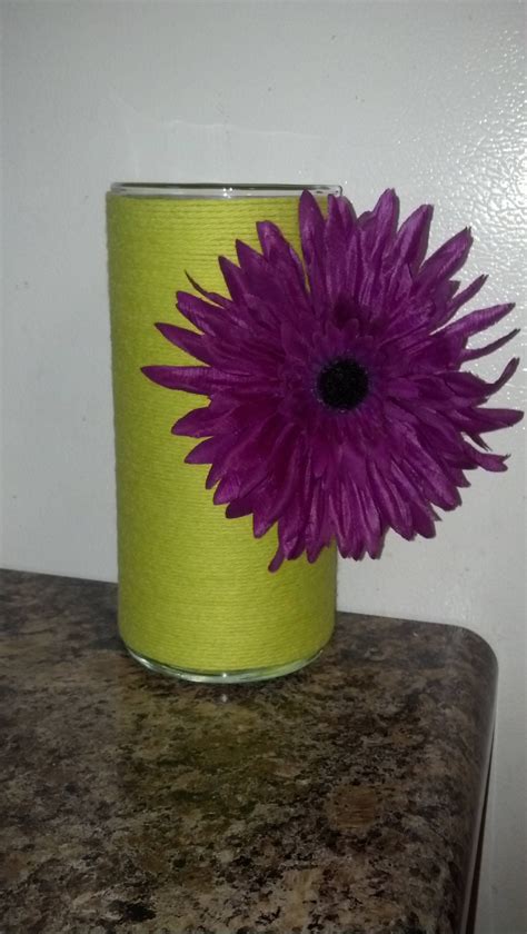 I decided to decorate dollar store jars with my flowers. Dollar store vase, yarn and a clip on flower, viola ...