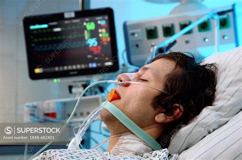 Patient Lying In A Special Bed Intubated Medical Appliances For