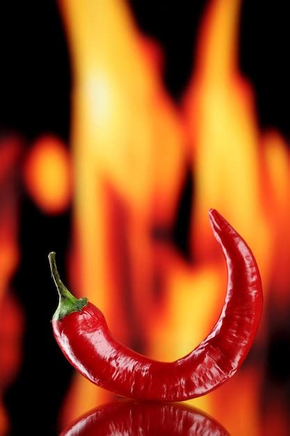 Premium Photo Red Hot Chili Pepper On Fire Background