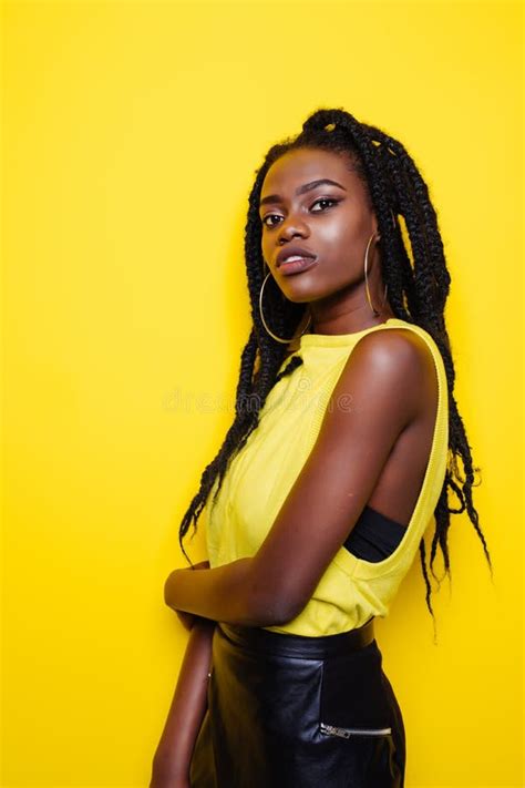 Beauty Portrait Of Young African American Girl Posing On Yellow