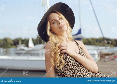 Girl On The Background Of Yachts Sailing Boats Smiling A Beautiful Blonde Is Sitting On The