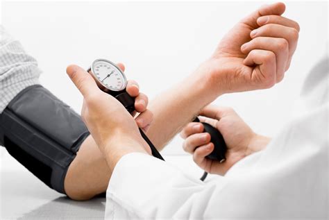 Person Performing Manual Blood Pressure Monitor Hd Wallpaper