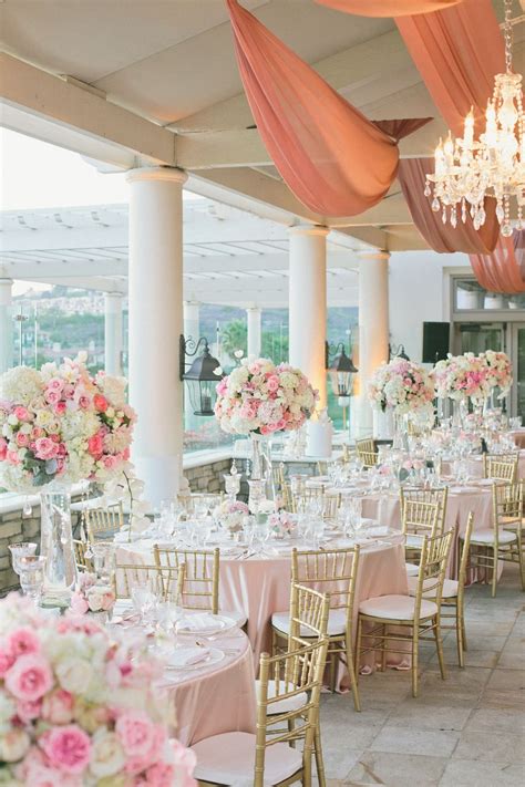The Tables Are Set With Pink And White Flowers In Vases Candles And