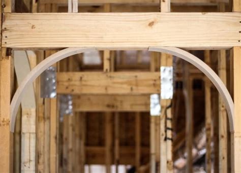 An Arch In The Middle Of A Building Being Built With Wooden Framing And
