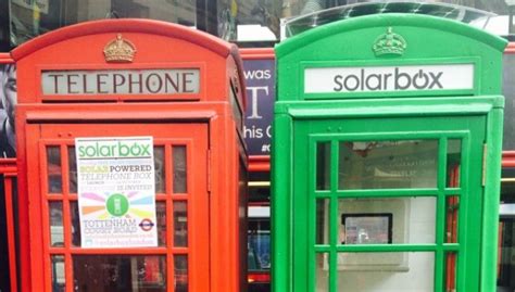 Two Red And Green Telephone Booths Next To Each Other