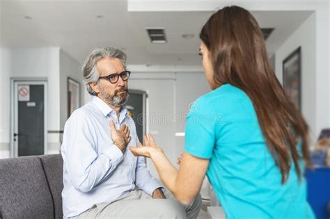 Doctor Consulting Patient In Hospital Waiting Room Patient Sitting Stock Image Image Of