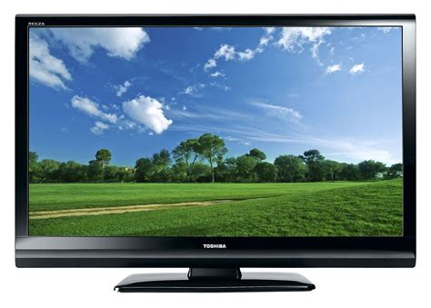 A Flat Screen Tv Sitting On Top Of A Wooden Stand In Front Of A Green Field