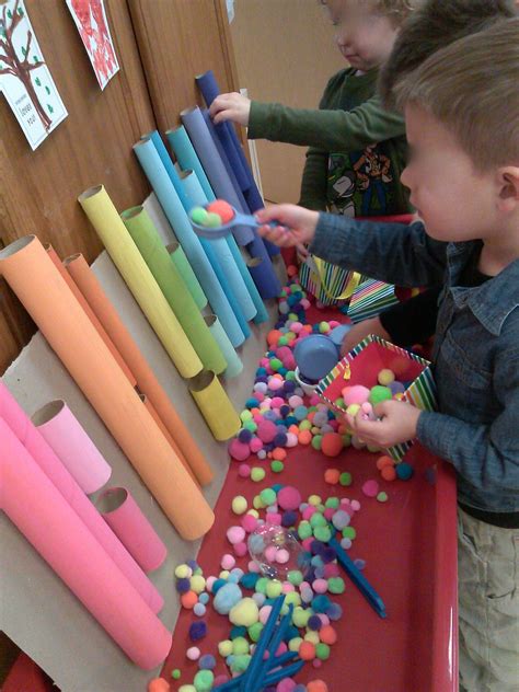 Pom Pom sorting using tongs and scoops. Sensory table | sensory table