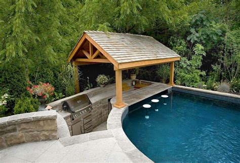An Outdoor Bbq Area With Kitchen Shelter And Swim Up Bar Is Located At